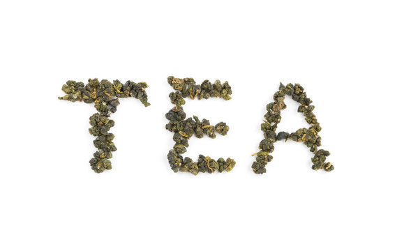 Fresh Tieguanyin Oolong tea leaves arranged in English letters as "TEA" word on white background for hot or cold drinks
