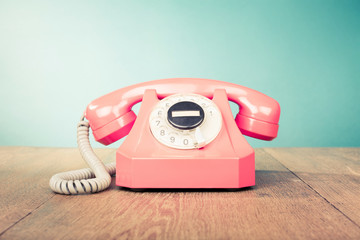 Retro telephone front mint green wall background. Old style filtered photo