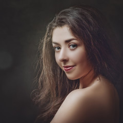 Fototapeta premium Grungy female portrait. Retro styled classic dramatic light