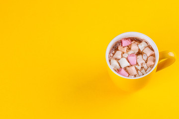 Yellow cup of hot cocoa with marshmallows