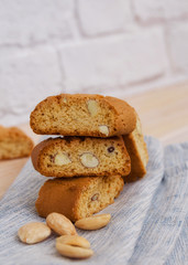 Close upf of italian biscotti cantuccini or cantucci ob linen napkin. Typical  almond sweet biscuits consumed in Italy.