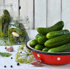 Preservation of pickling cucumber. Preparation of conservation from organic vegetables on a light background. Homemade organic crunch green pickles in a jar. Copy space