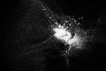 White powder exploding isolated on black background