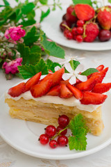 Napoleon cake with strawberries. Wooden background. Close-up. Top view