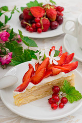 Napoleon cake with strawberries. Wooden background. Close-up. Top view