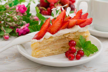 Napoleon cake with strawberries. Wooden background. Close-up. Top view