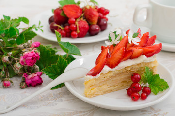 Napoleon cake with strawberries. Wooden background. Close-up. Top view