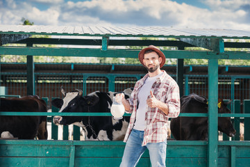 farmer with fresh milk in stall