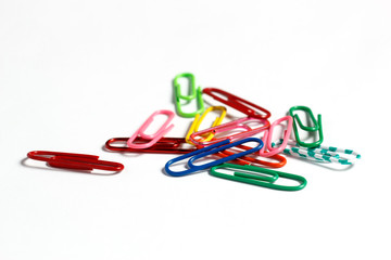 Multicolored paper clips on a white background