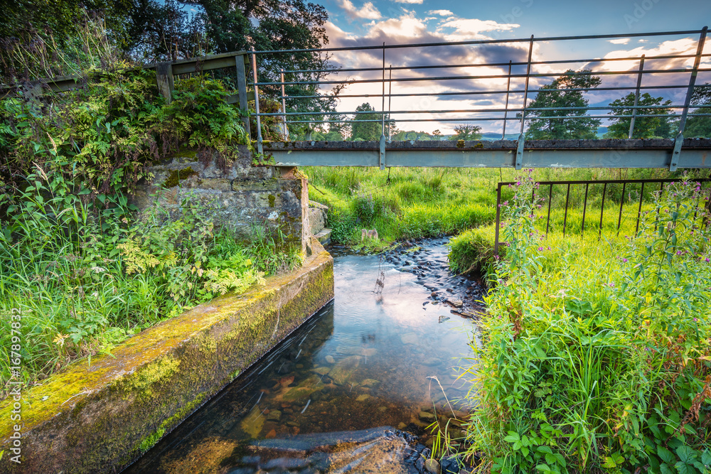 Sticker River Aln Footbridge / The River Aln runs through Northumberland from Alnham to Alnmouth. Seen here beginning to widen just after Alnham