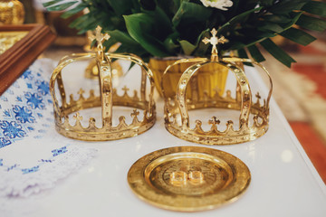 Fototapeta na wymiar Golden crowns lie on the table in church