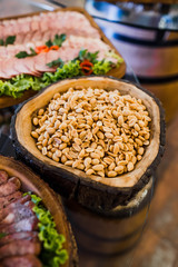 Wooden dish with salty peanuts