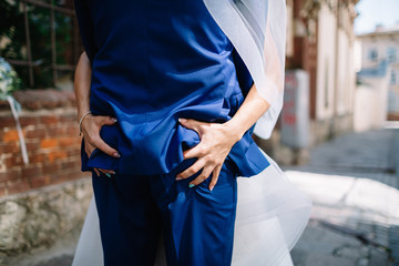 Bride holds tightly groom's ass