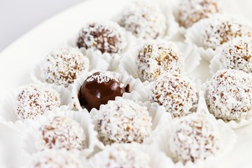 Date and almond pralines in ground coconut