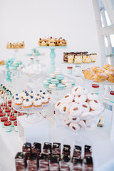 Candy bar with macaroons, eclairs, chocolate cakes