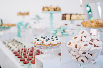 Candy bar with macaroons, eclairs, chocolate cakes