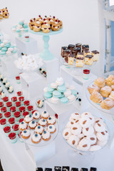 Candy bar with macaroons, eclairs, chocolate cakes