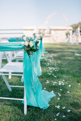 Mint cloth hangs from white chair on the lawn