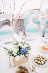 Bouquet of roses decorated with wicker stands on the table