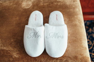 White slippers with lettering 'Mr' and 'Mrs'