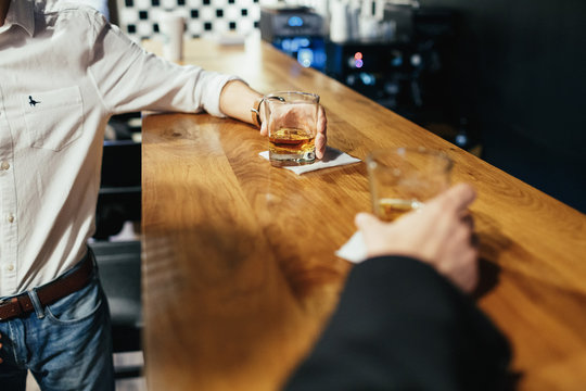 Man drink whisky standing at the bar