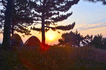 Background of camp over sunrice in mountains in morning