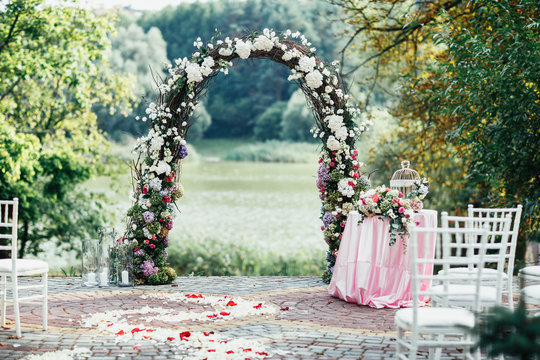 Beautiful wedding altar made of roses stands in the garden
