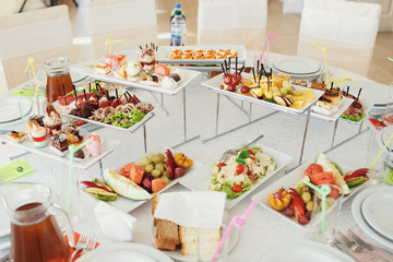 Sliced fruits and salads served on the table