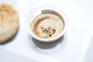 Hummus with cedar nuts in the jar and fresh pita
