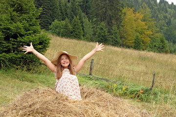 Naklejka na ściany i meble beautiful little girl with hands up enjoys nature summer season