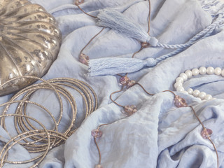 Vintage jewelry on blue fabric background