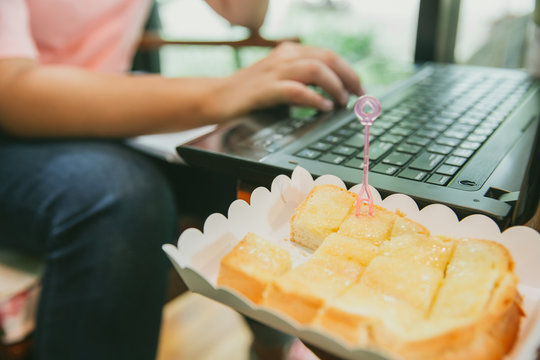 Young Women Eating Sweet Fat Unhealthy Food When Working With Computer Laptop