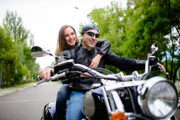 Naklejka na ściany i meble Guy and girl on a motorcycle.