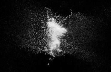 White powder exploding isolated on black background