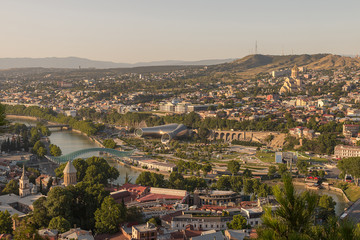 Fototapeta na wymiar Tbilisi, Georgia - July 15, 2017: Panoramic view of old Tbilisi city in the sunny evening