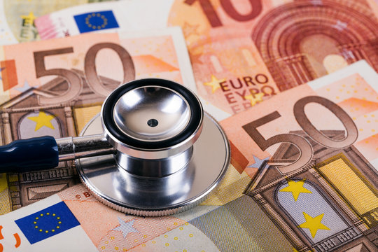 healthcare cost and insurance concept. stethoscope on euro money