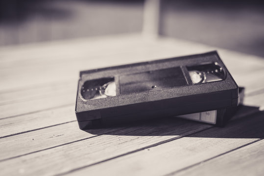  Stack Of VHS Video Tape Cassette On White Wooden Table, Retro Filter