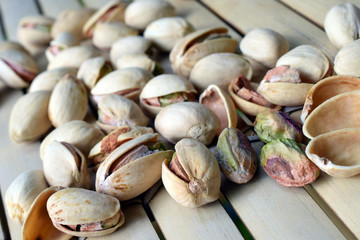 Pistachio nuts on bamboo table. Horizontal image.