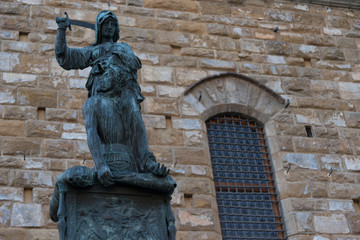 Fototapeta na wymiar Statue in front of the Facade of Old Palace called Palazzo Vecchio at the Piazza della Signoria in Florence, Tuscany, Italy