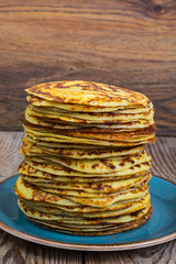 High stack of pancakes in rustic style