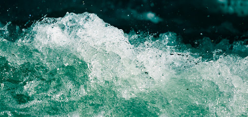 Splash of stormy water in the ocean on a black background