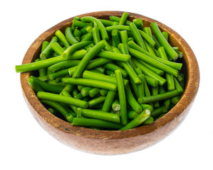 Wooden bowl with green pods, isolated on white background