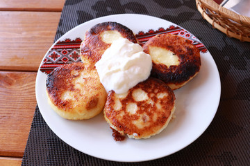 Syrniki - Cottage cheese pancakes, Fritters of cottage cheese - traditional Ukrainian and Russian cuisine
