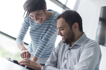 Obraz premium Two Business People Working With Tablet in startup office