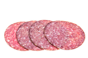 Round slices of chopped sausage on white background