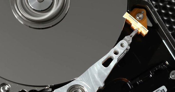 Operating hard disk drive on dark background.