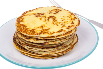 Crispy thin pancakes on plate, light background