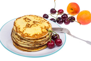 Crispy thin pancakes on plate, light background