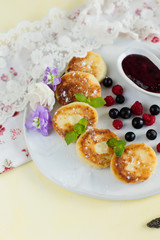 Cheesecake with berries and mint on a yellow background (close-up)