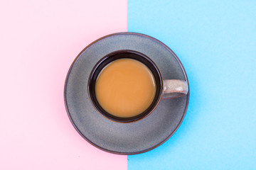 Cup of coffee with milk on pastel background